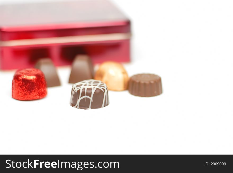 Elegant chocolates in front of a red box.Selective focus.
