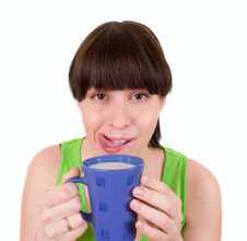 The Girl Drinks Milk From A Blue Cup Stock Photo