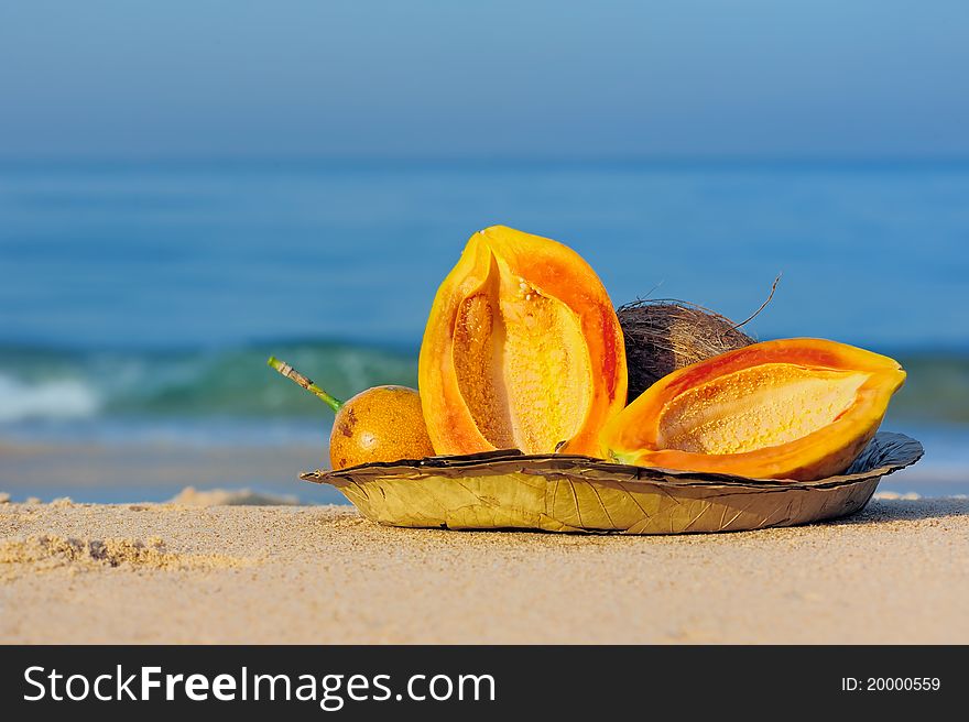 Exotic tropical fruit on the leaves plate on the sand. Exotic tropical fruit on the leaves plate on the sand