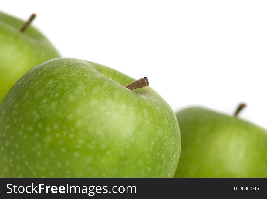 A group of green apples with stalks. A group of green apples with stalks
