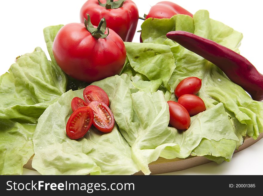 Tomatoes with chilli on lettuce leaf