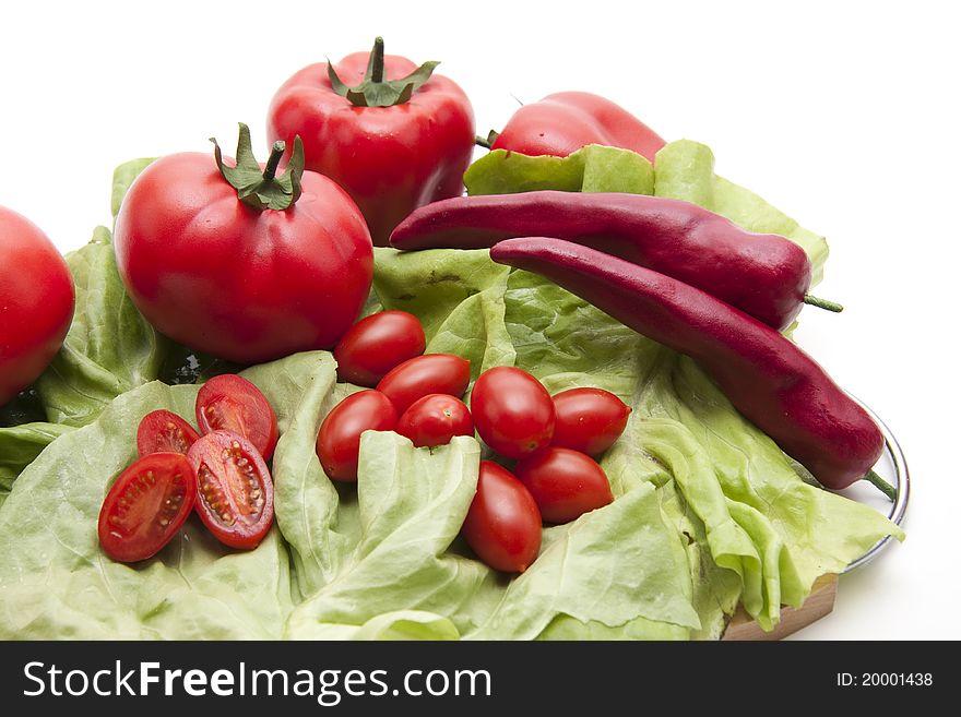 Tomatoes with chilli on lettuce leaf