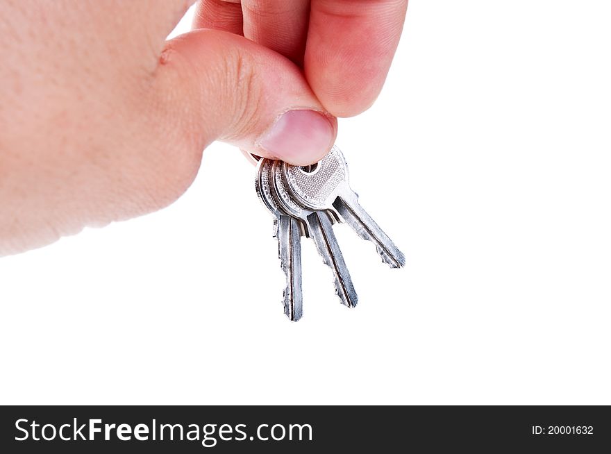 Three silver keys in a hand isolated on white background