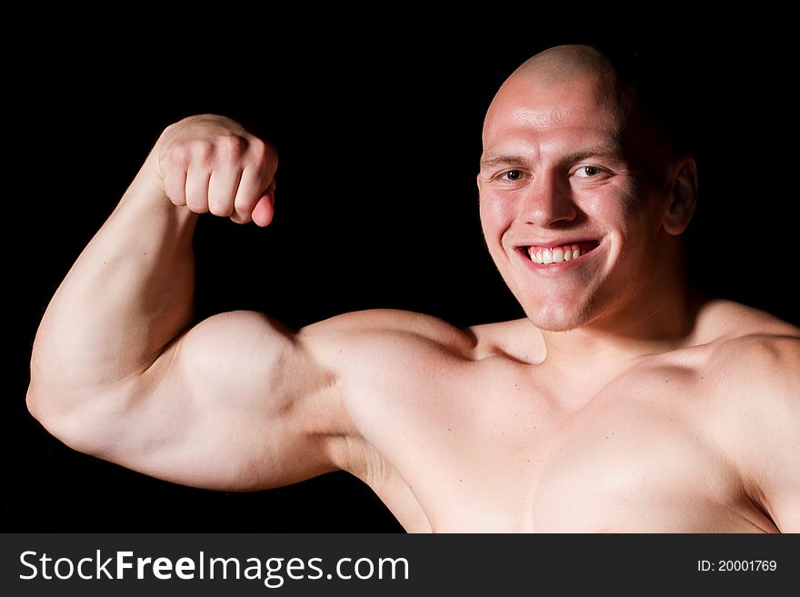 Pumped white guy posing on black background. Pumped white guy posing on black background