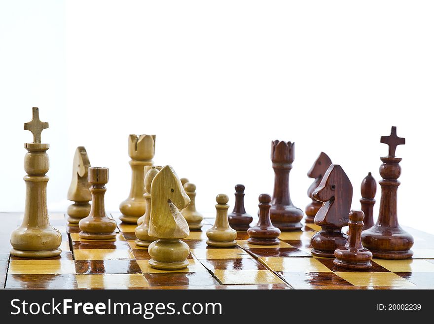 Wooden chess teams on white background. Wooden chess teams on white background