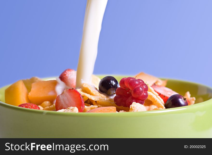 Bowl full of cereals with fresh berry fruits and milk. Bowl full of cereals with fresh berry fruits and milk