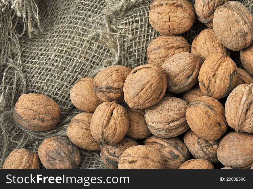 Walnuts on a background of rough cloth. Walnuts on a background of rough cloth