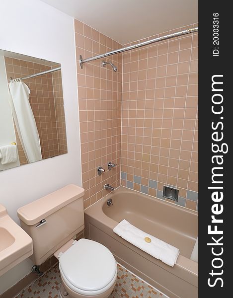 Interior of clean and simple toilet and accompanying bathroom.