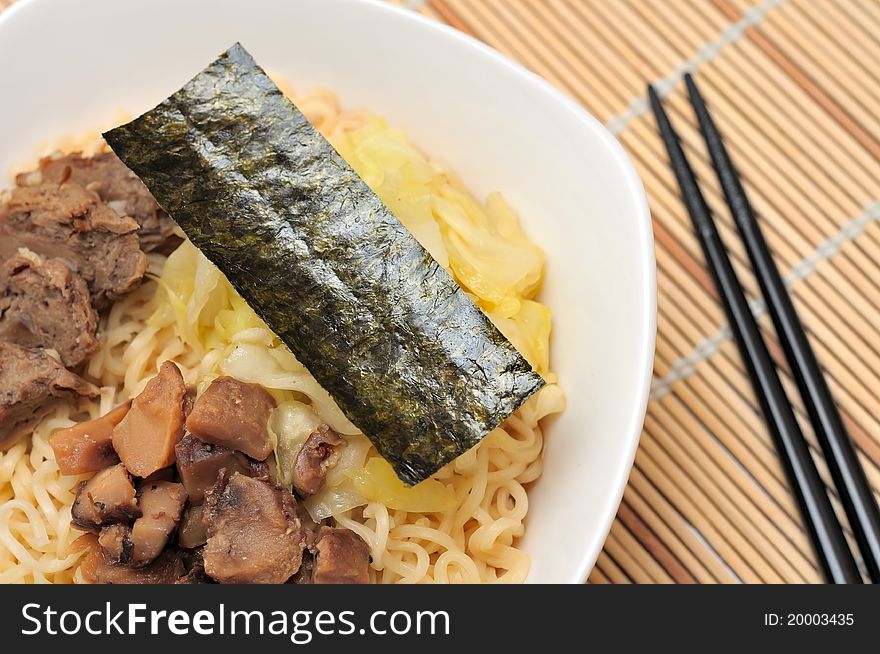 Japanese style yellow noodles served with seaweed. Japanese style yellow noodles served with seaweed.