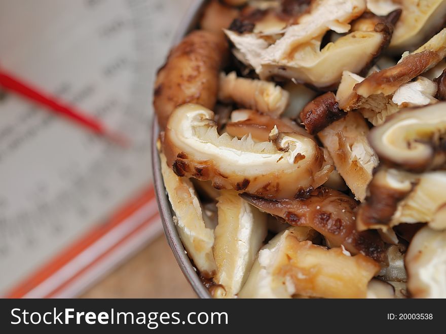 Freshly prepared mushrooms beside weighing machine.