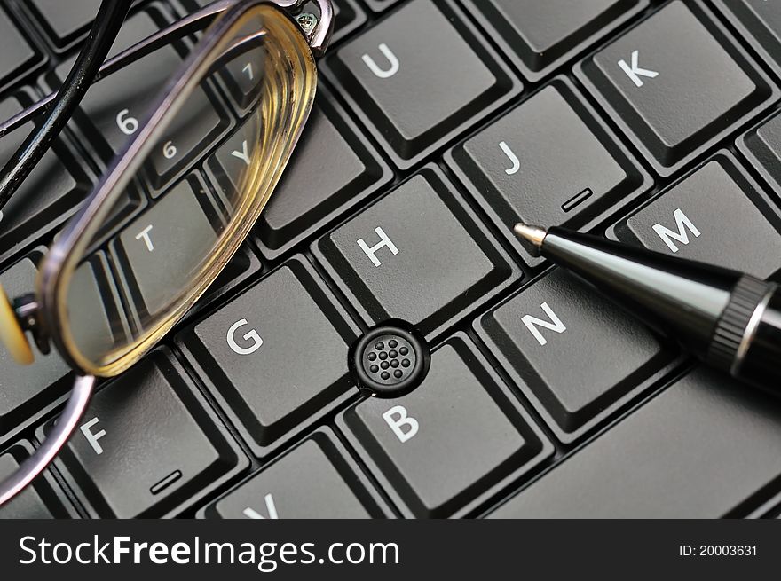 Keyboard, glasses and pen