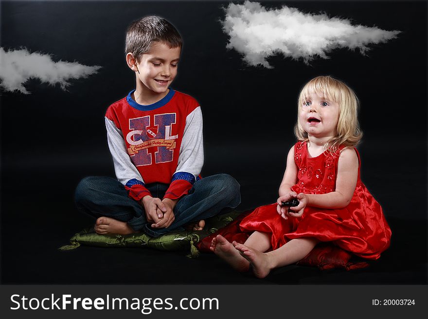 Studio shot of two children playing a fantasy game : 'Close your eyes, sister, and imagine we are in a fairy tale'. Studio shot of two children playing a fantasy game : 'Close your eyes, sister, and imagine we are in a fairy tale'...