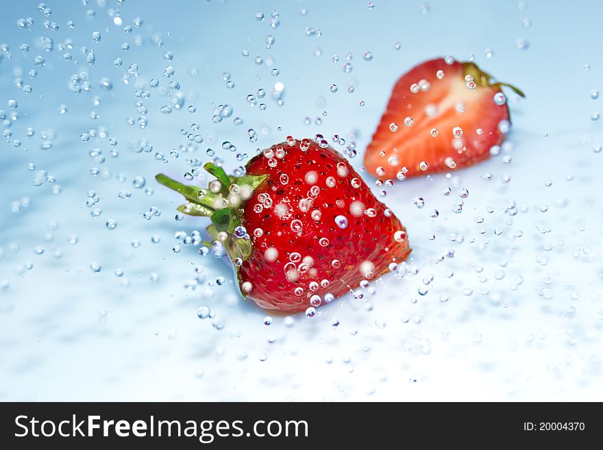 Juicy strawberry in water splash