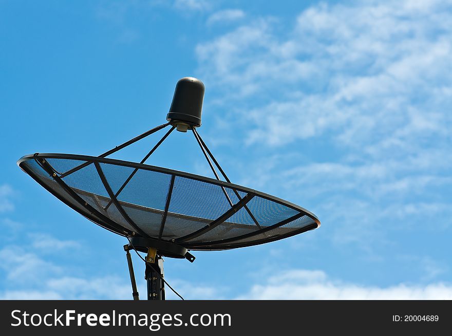A black satellite dish with blue sky
