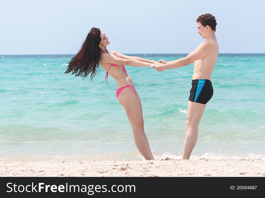 Young happy couple on beach. Young happy couple on beach