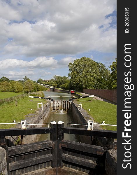 A view of the 16 locks on this stretch of the kennet and avon canal viewed from the bottom of caen hill near Devizes in Wiltshire England. Using the power of water the canal boats are transported up and down this steep hill all year around. A view of the 16 locks on this stretch of the kennet and avon canal viewed from the bottom of caen hill near Devizes in Wiltshire England. Using the power of water the canal boats are transported up and down this steep hill all year around.