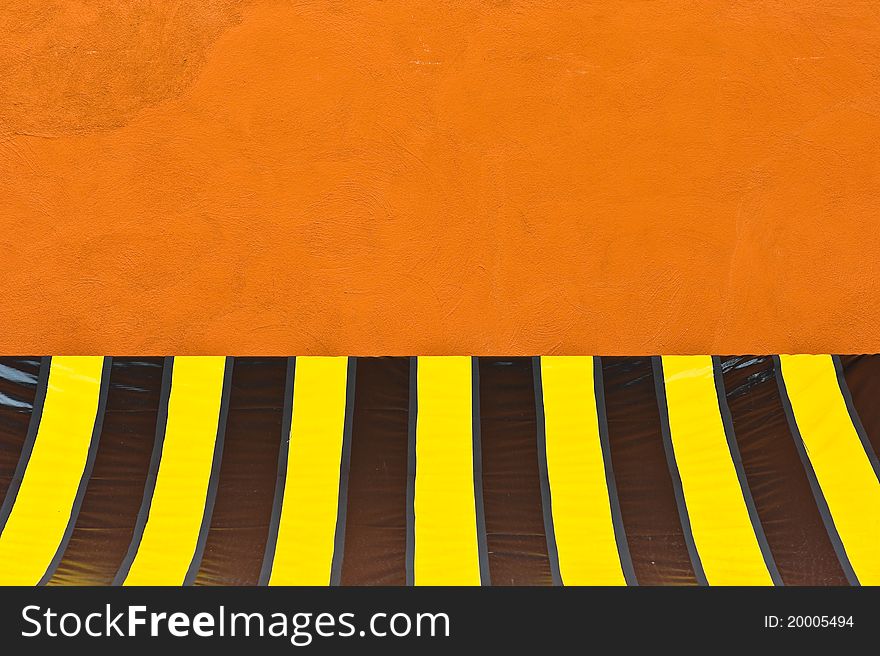 A colorful plastic tent at orange wall