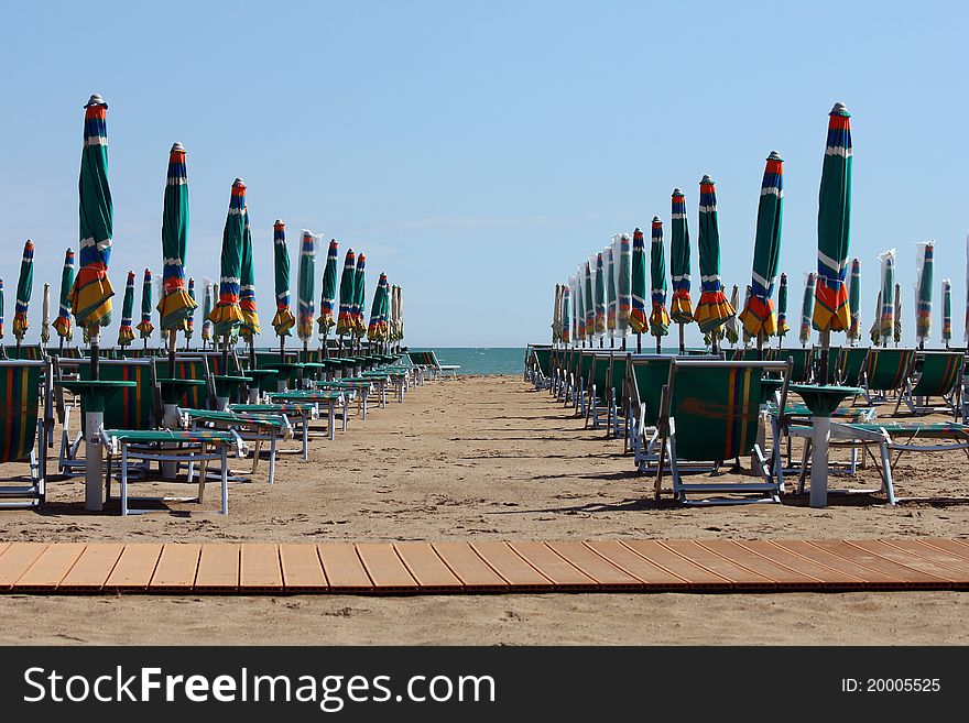 Rows of sun-lounger and sunshades on the beach. Rows of sun-lounger and sunshades on the beach