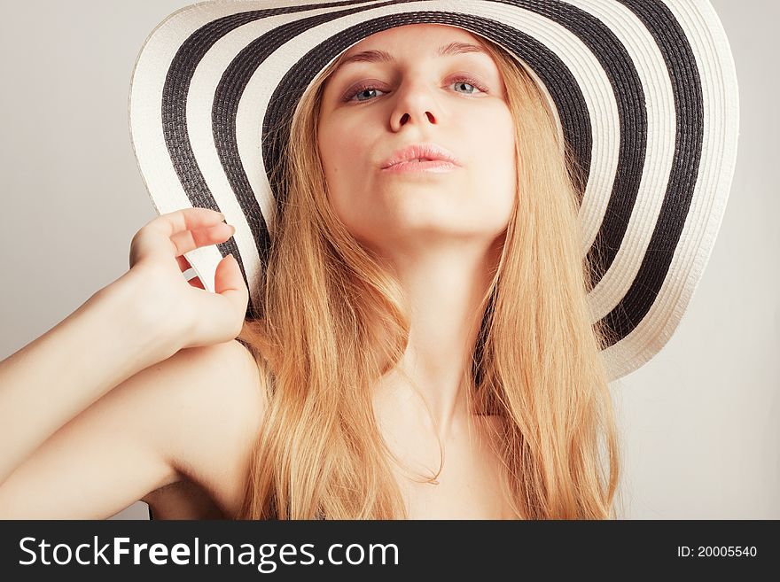 Beautiful young attractive woman posing in a summer hat. Beautiful young attractive woman posing in a summer hat
