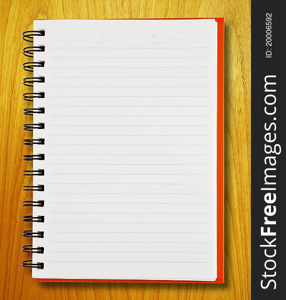 Notebook on wood pattern background