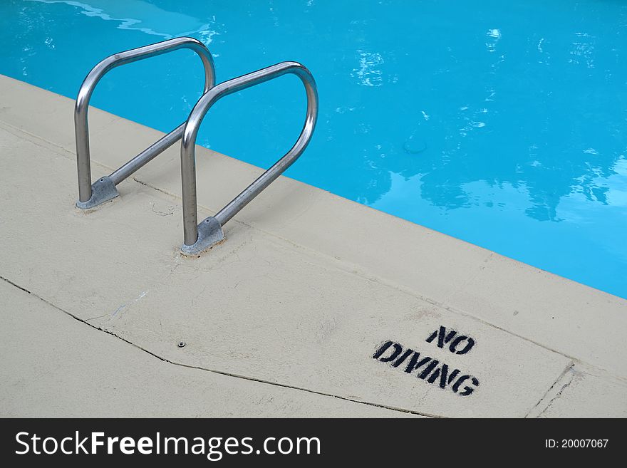 Pool entry and exit with a no diving sign