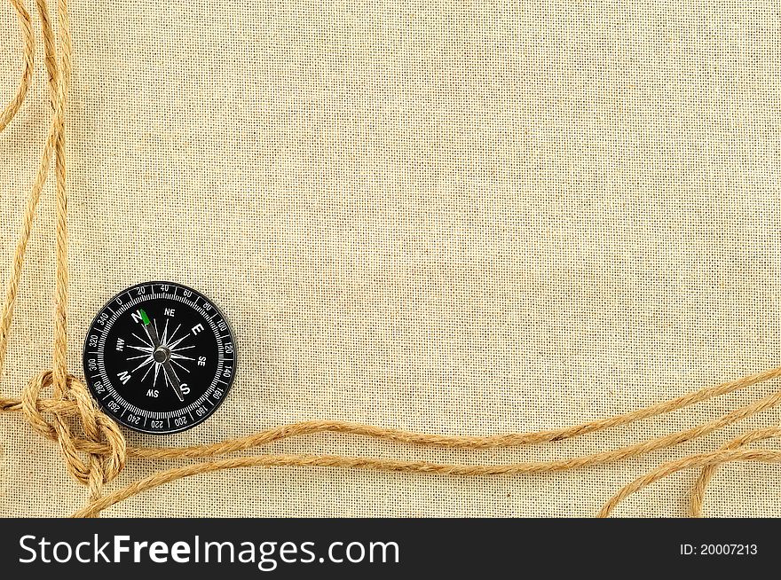 Compass and rope on with a canvas of burlap