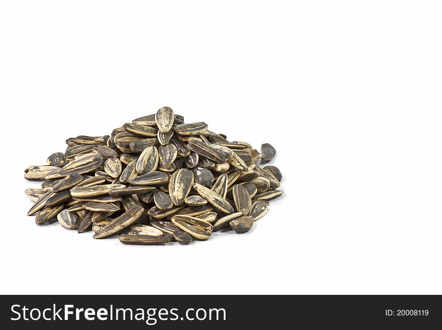 Roasted sunflower seeds on white background. Roasted sunflower seeds on white background.