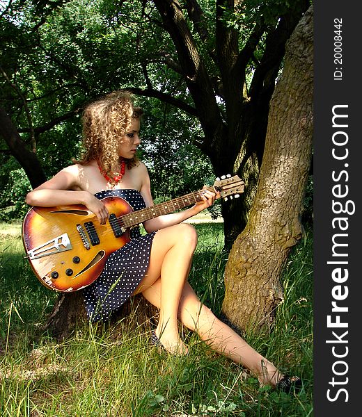 Girl on the picnic with guitar