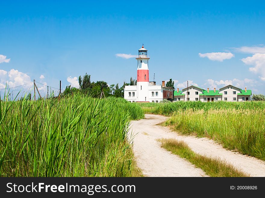 Road in reed to the old lighthouse. Octagonal masonry tower with red and white bands. It is situated in the North side of Sea of Azov, Zaporizhia Oblast to provide active aid to navigation.