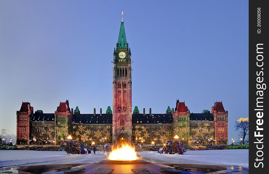 The Centre Block and the Centennial flame decorated for Christmas at dusk. The Centre Block and the Centennial flame decorated for Christmas at dusk