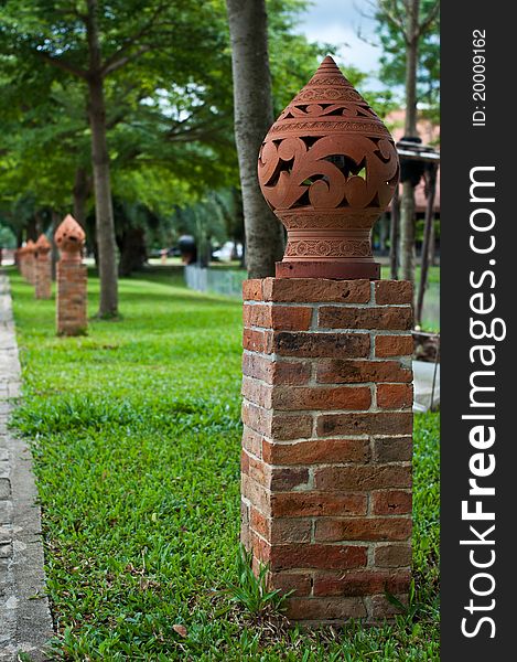 Thai style ceramic street lamp on red brick stand. Thai style ceramic street lamp on red brick stand