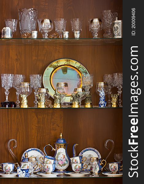 Decorative ware adorning glass shelves in the living room cabinet. Decorative ware adorning glass shelves in the living room cabinet