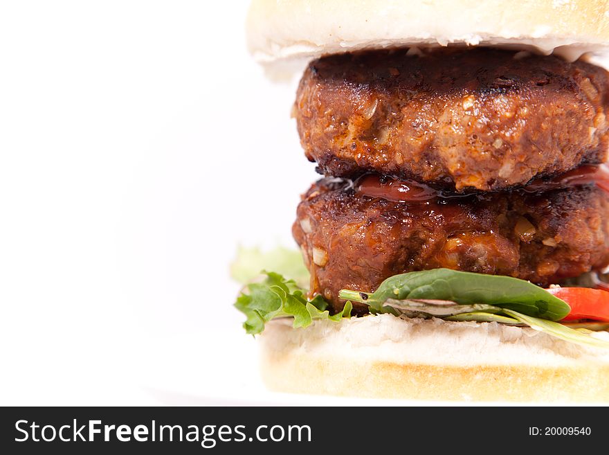 Macro picture of double beef burger in white background.