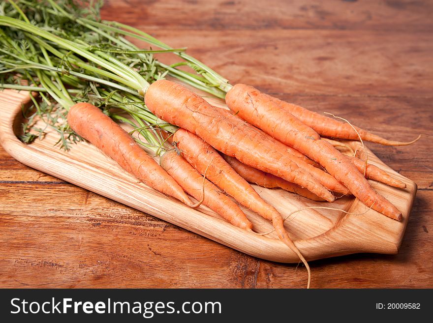 Fresh carrots on the wooden table. Fresh carrots on the wooden table.