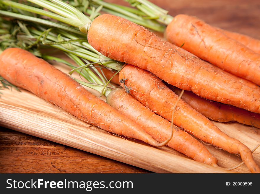 Close up picture of carrots on wooden table