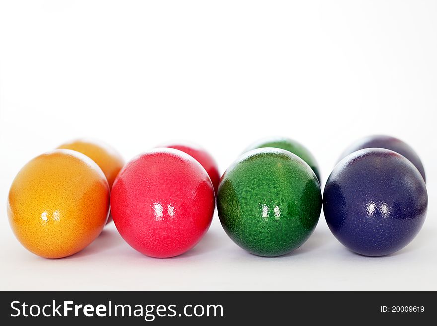Strung colorful easter eggs isolated on white background