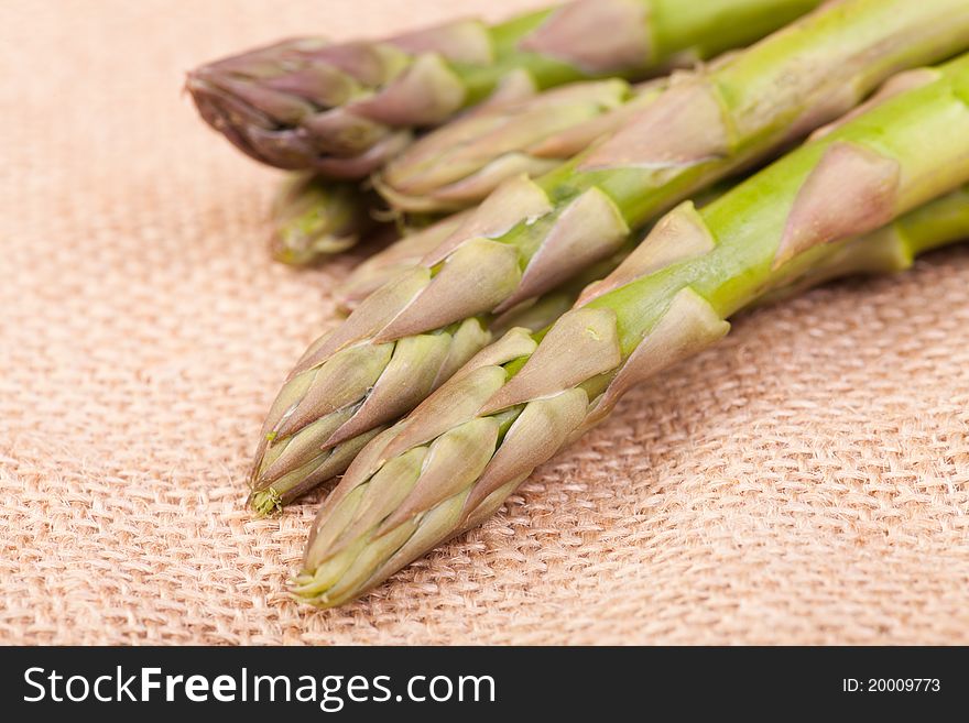 Loose green fresh asparagus on the brown hemp. Loose green fresh asparagus on the brown hemp.