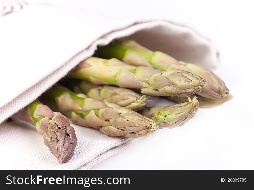 Asparagus wrapped with table cloth in white background. Asparagus wrapped with table cloth in white background.