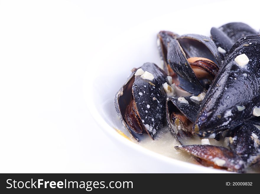Mussels in the bowl in white background.