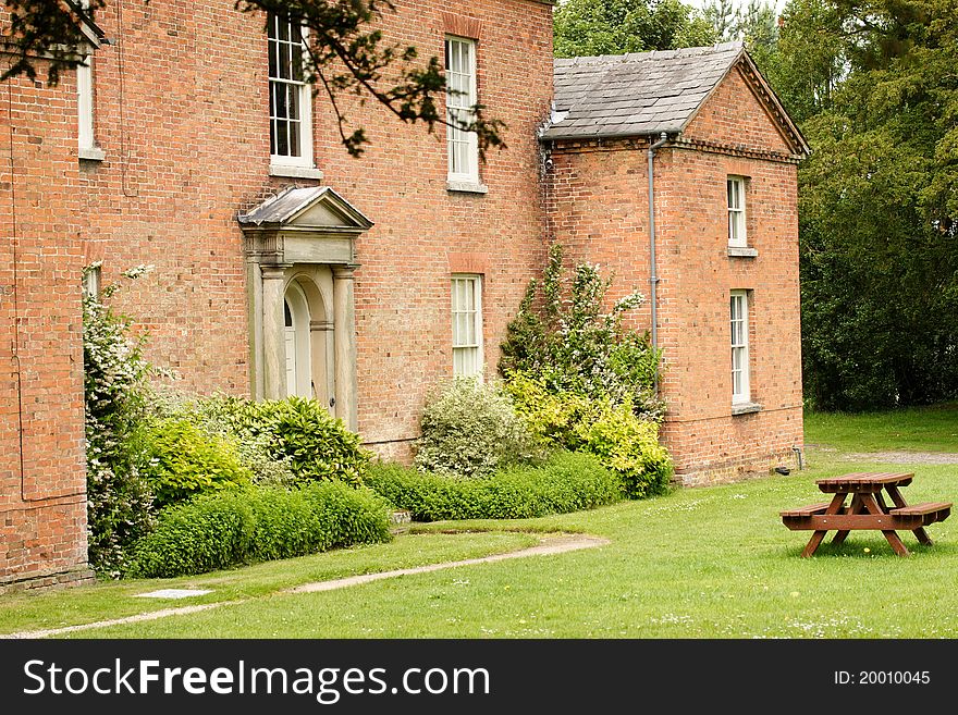 A building in the Shugborough estate Staffordshire England, the home of Lord Lichfield. Showing park bench. A building in the Shugborough estate Staffordshire England, the home of Lord Lichfield. Showing park bench.