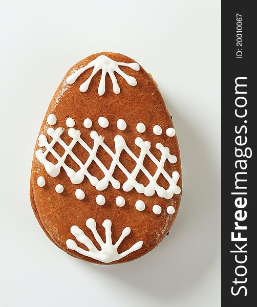 Egg-shaped gingerbread cookie decorated with white frosting. Egg-shaped gingerbread cookie decorated with white frosting