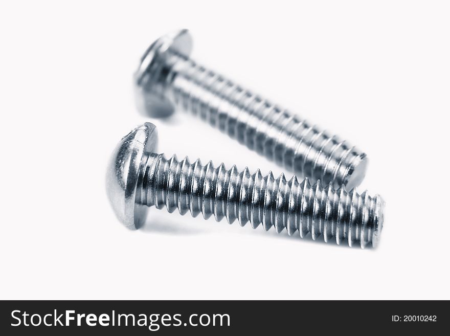 Two metal screws against white background