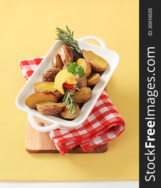 Halves of baked potatoes in a casserole dish