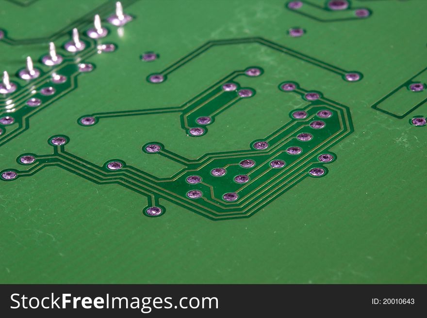 Close-up photograph of a green circuit board.