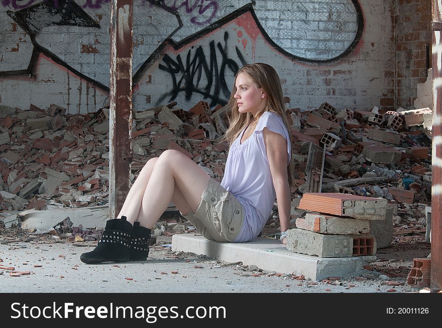 One beautiful woman is sit in a place surrounded by bricks. 
The location looks like an abandoned place and so that it is on ruins. The girl is looking straight to the left of the camera. She dresses one short, boot and one clear t-shirt. One beautiful woman is sit in a place surrounded by bricks. 
The location looks like an abandoned place and so that it is on ruins. The girl is looking straight to the left of the camera. She dresses one short, boot and one clear t-shirt.