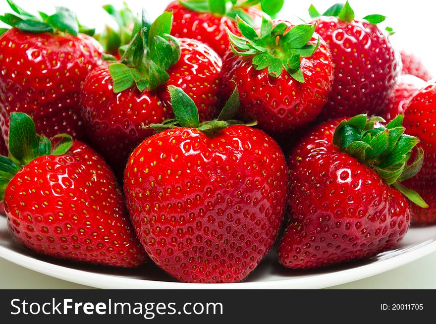 Fresh organic strawberries on a plate.