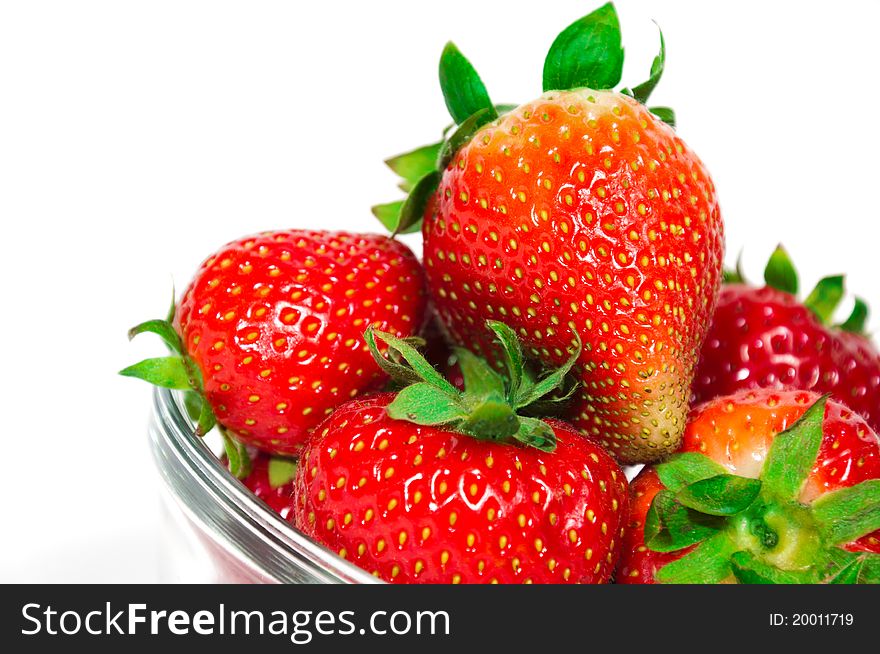 Fresh organic strawberries in a glass bowl, isolated. Fresh organic strawberries in a glass bowl, isolated