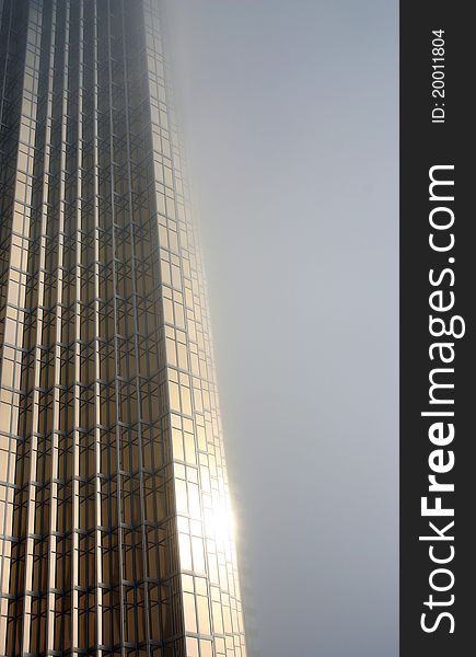 Gold Glass Skyscraper in the fog. Gold Glass Skyscraper in the fog