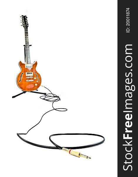 Orange electric guitar and cord isolated on white