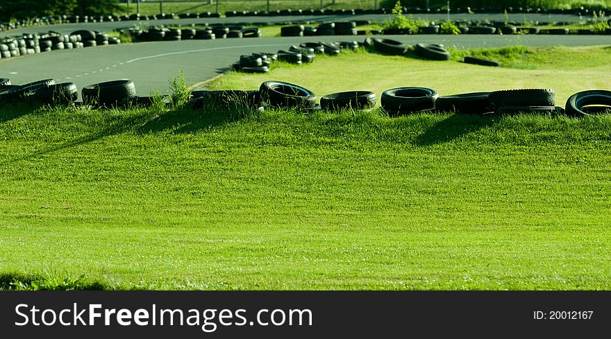 Tires being used as a safety barrier on go-cart track. Tires being used as a safety barrier on go-cart track